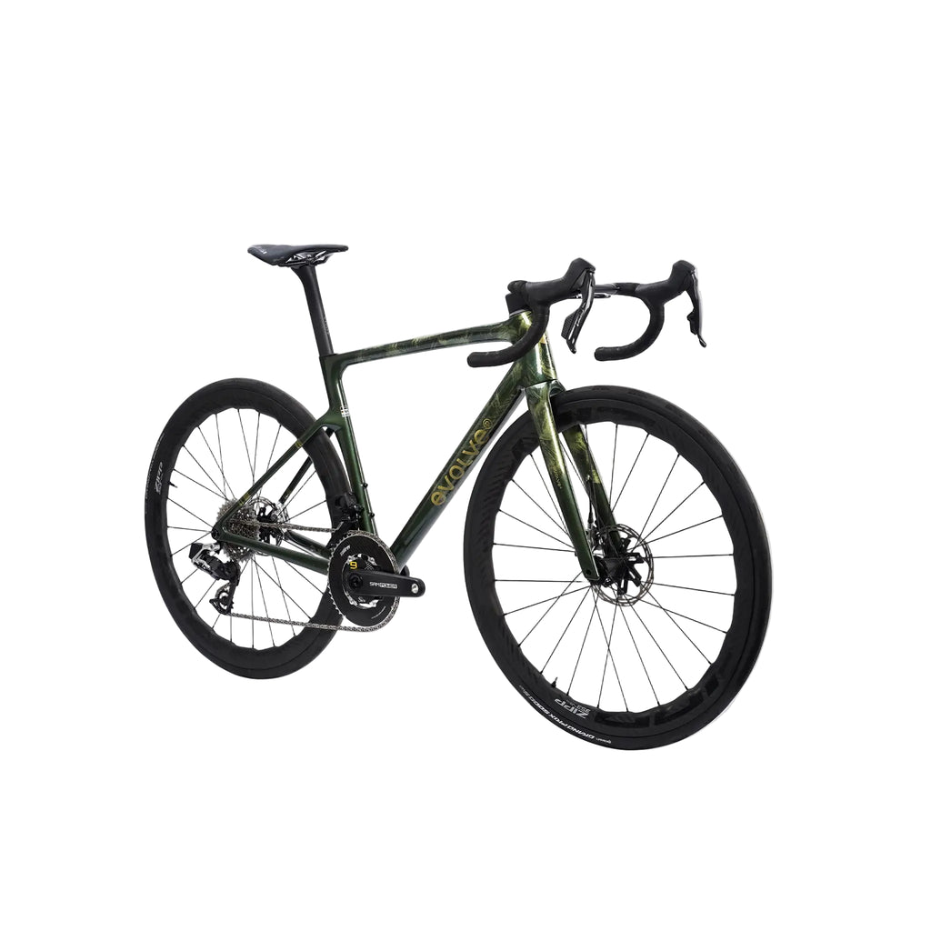 A drop-bar road bicycle with a dark olive green and black camouflage frame, black wheels, and black components, shown against a light gray background.