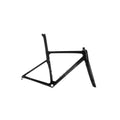A black carbon fiber road bicycle frame, shown from a side profile view against a light gray studio background. The brand name 'EVOLVE' is printed in white on the down tube.