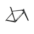 A black carbon fiber road bicycle frame with the brand name 'TIME' in white on the down tube, shown against a dark gray studio background.